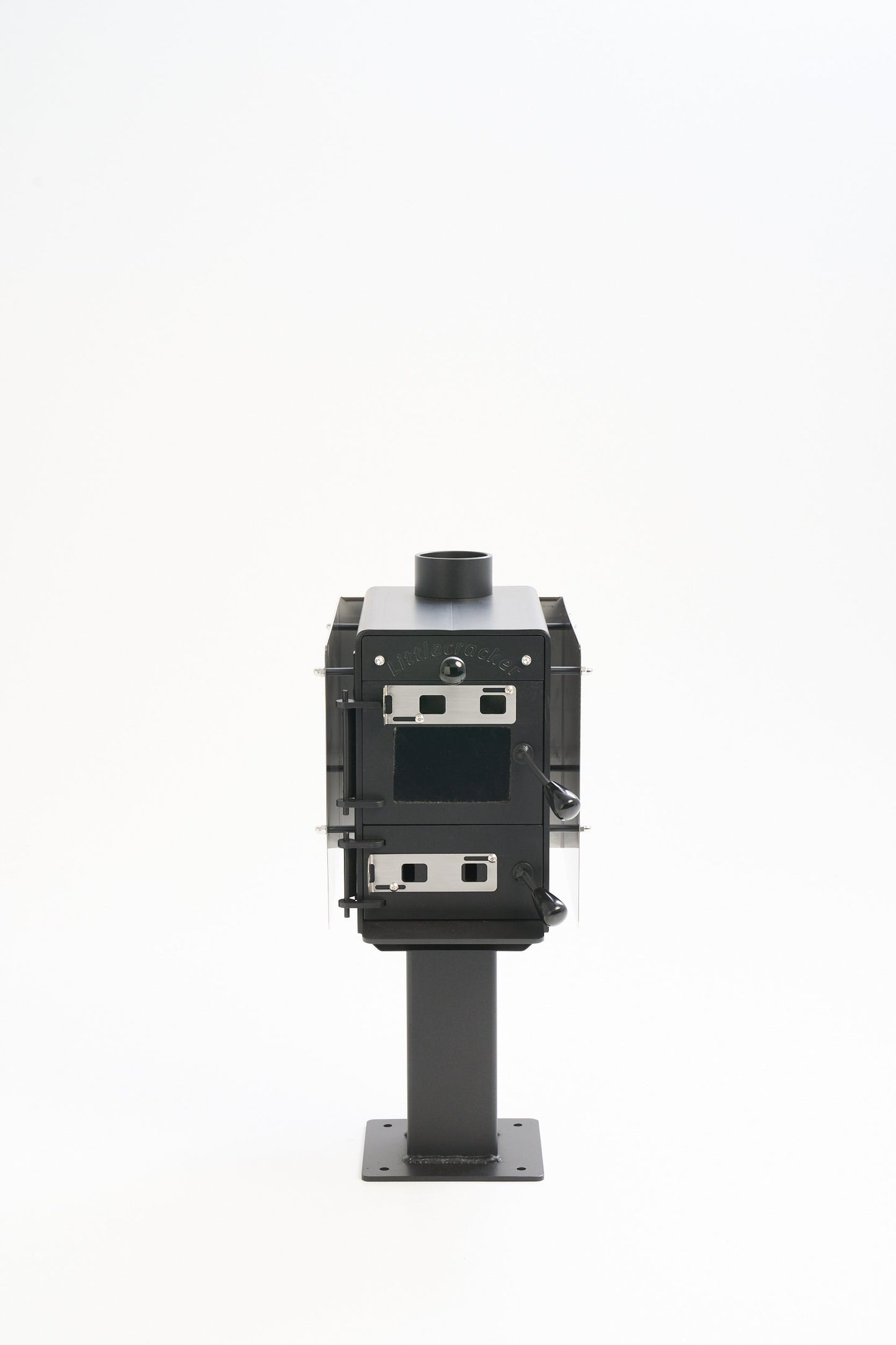 Little Cracker multi-fuel fire heater with flue system for small spaces.