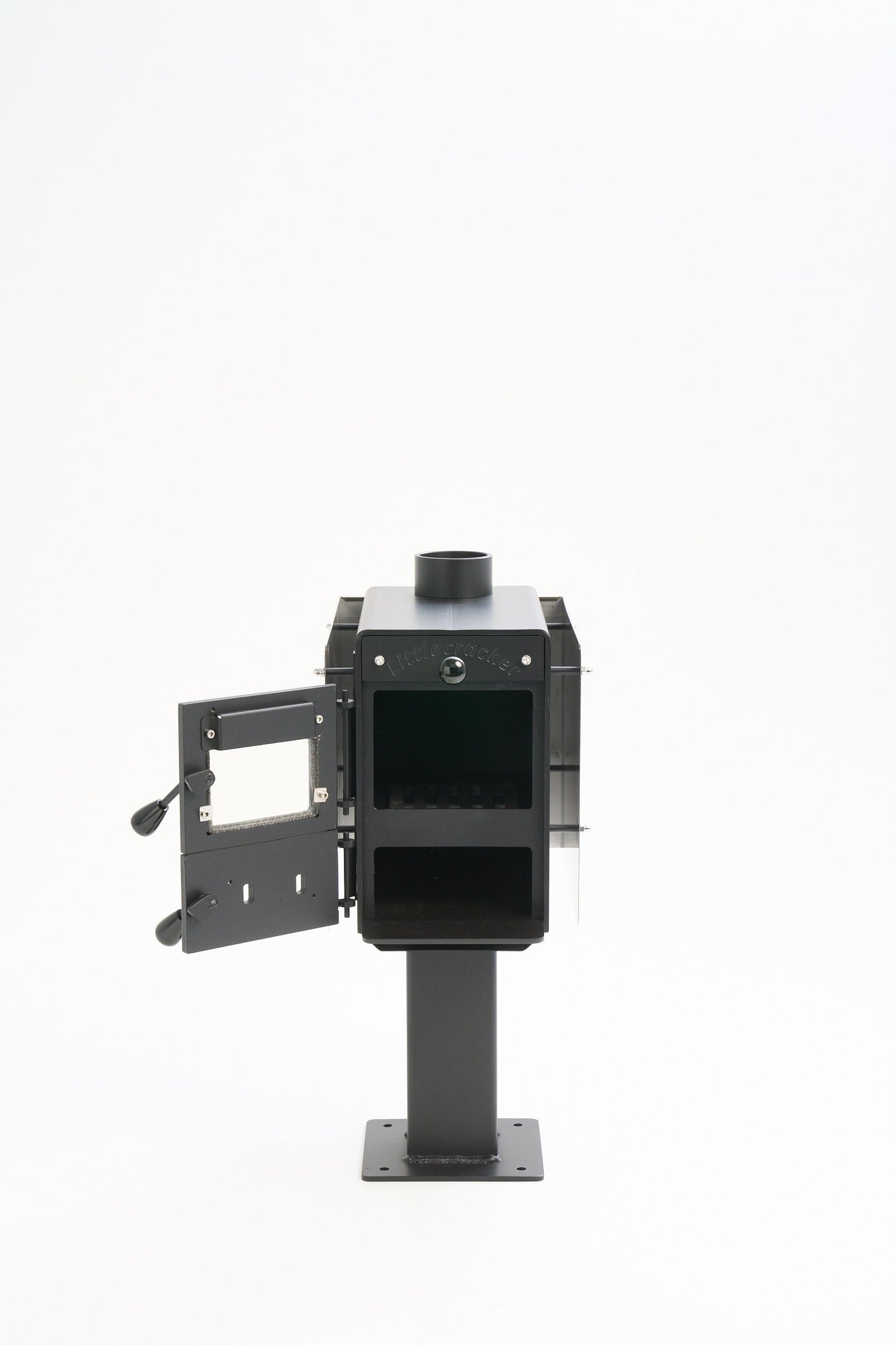 Little Cracker multi-fuel fire stove for compact spaces with open door.
