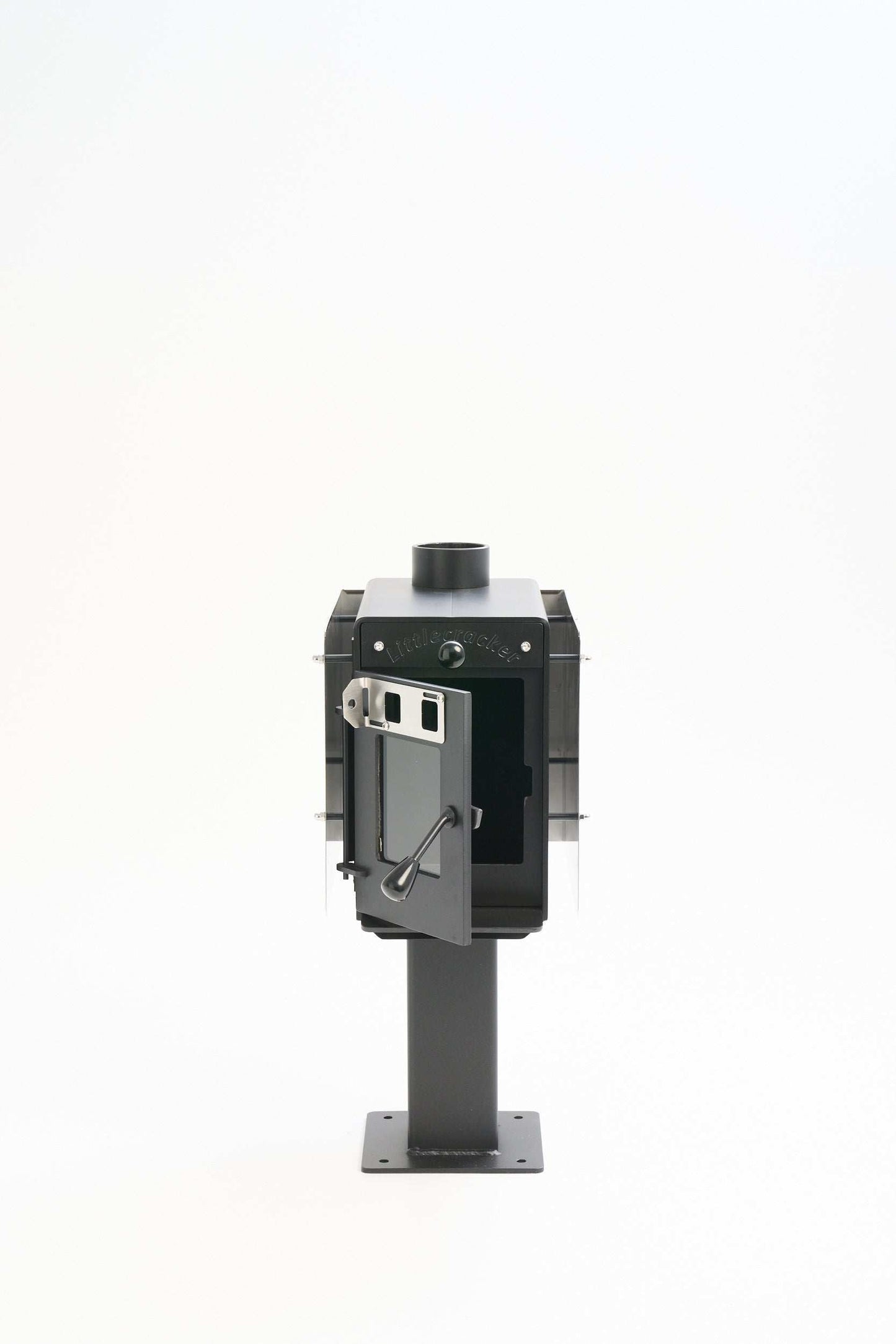 Little Cracker Woody solid fuel heater with open door, includes 4m flue system for dwelling installation.