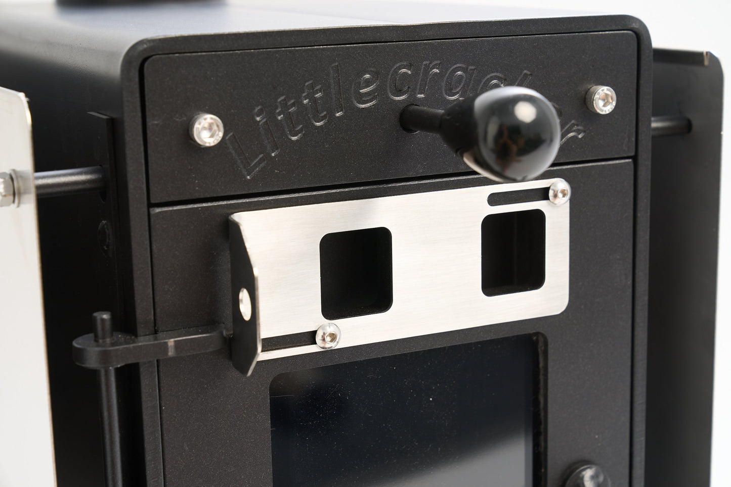 Little Cracker Woody compact wood burner close-up with steel construction for motorhomes and tiny homes.