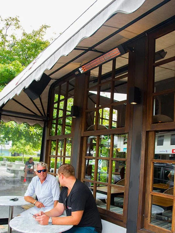 Infratech SL24 2.4kW Heater in outdoor setting, black shadow design, energy-efficient warmth.