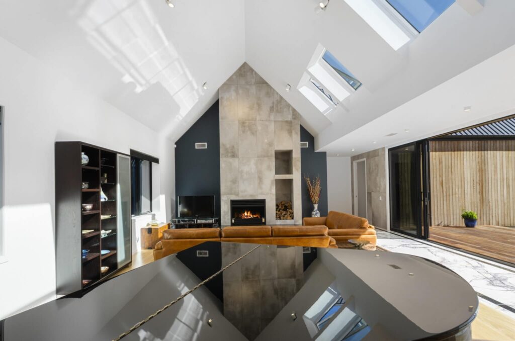 Warmington SI900 General Fire System in modern living space with skylights and sliding glass doors.