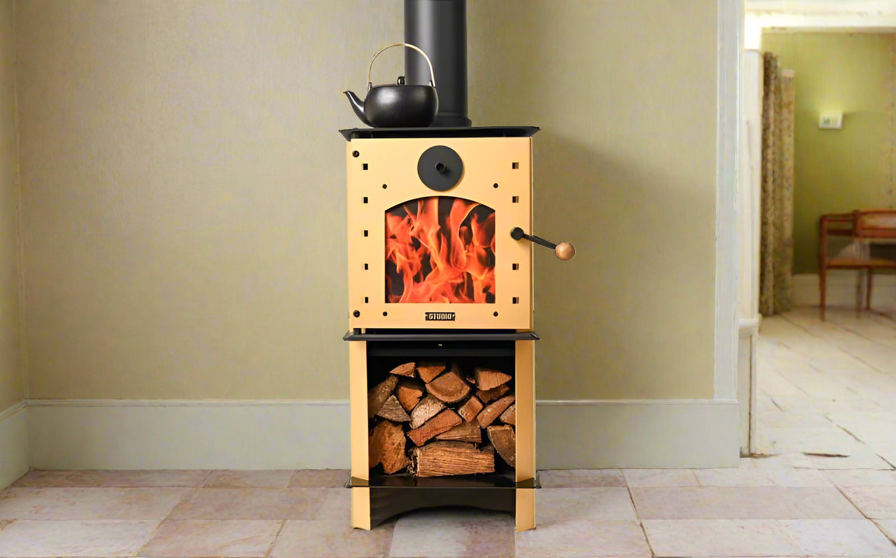 Warmington GOLD Studio 14 woodburner with flue system, featuring gold design, cooktop, and wood storage. Suitable for small to medium homes.