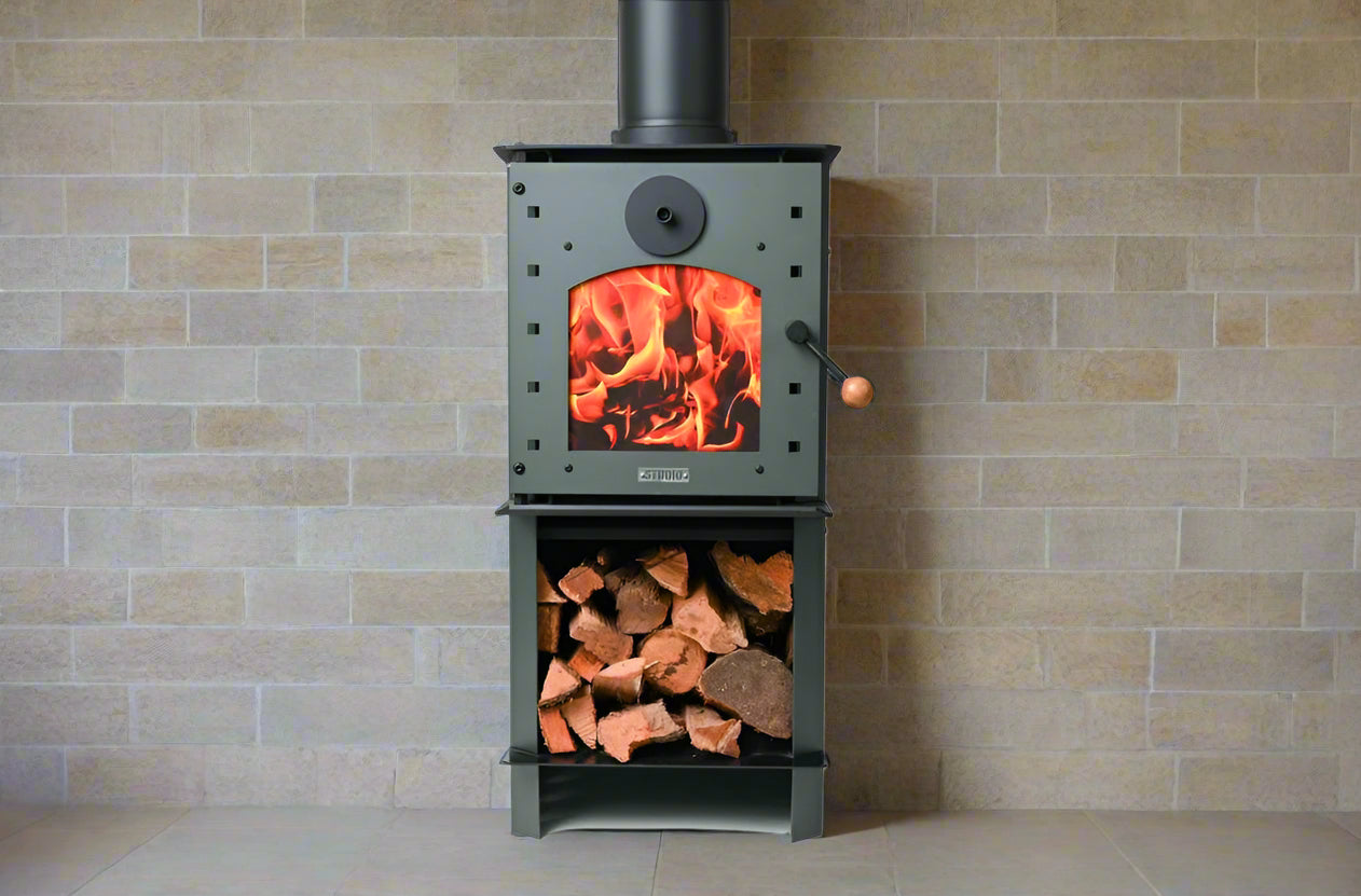 Warmington GREEN Studio 14 woodburner with flue and wood storage.