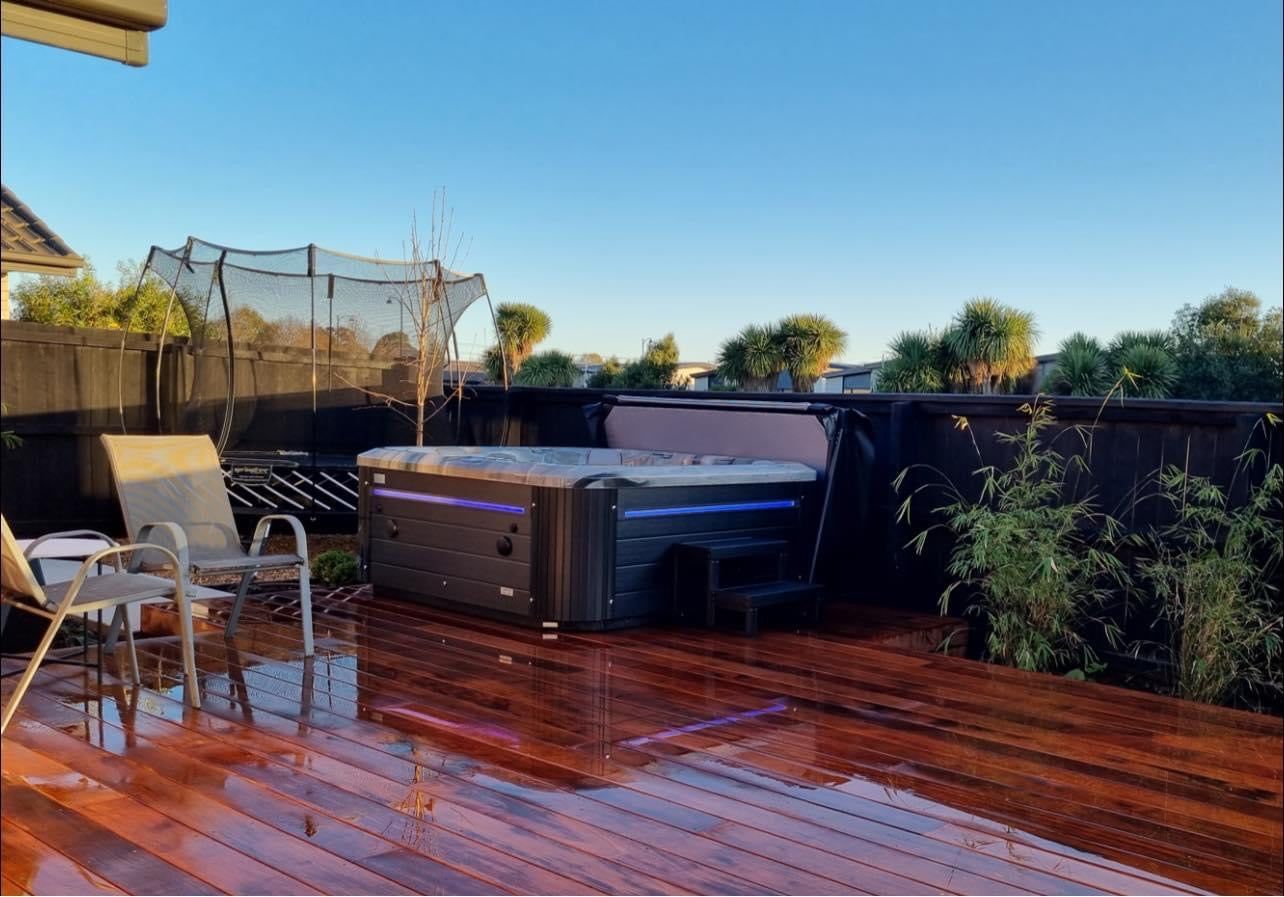 Sensation Retreat Spa Pool on a wooden deck with seating and garden view.