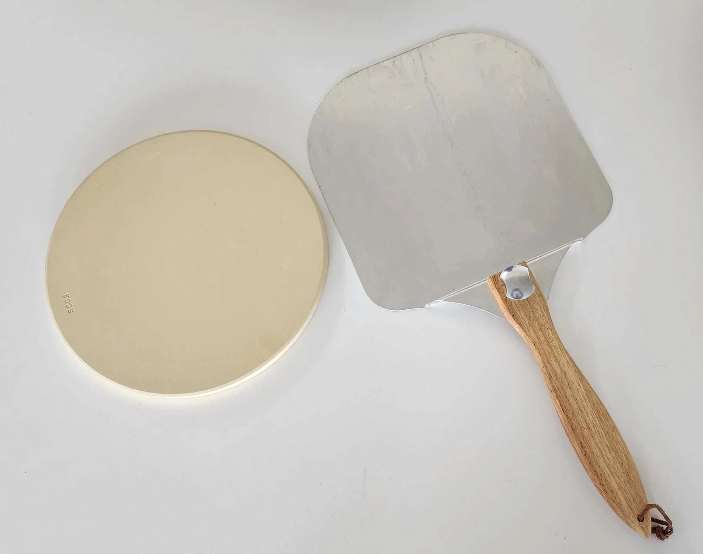 Pizza kit with stone and peel for Obelisk outdoor fire.