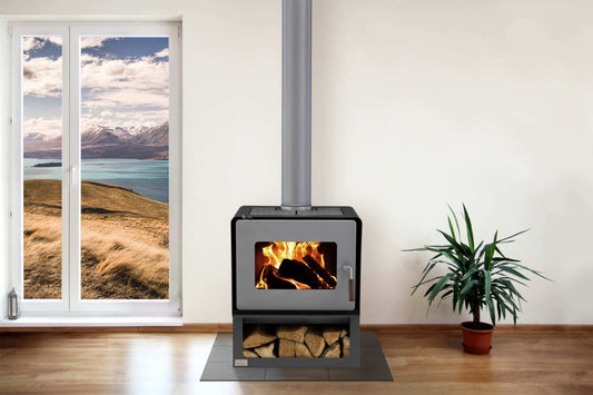 Woodsman Flare wood fire with wood box base and 4.2m flue system in a cozy room setting.