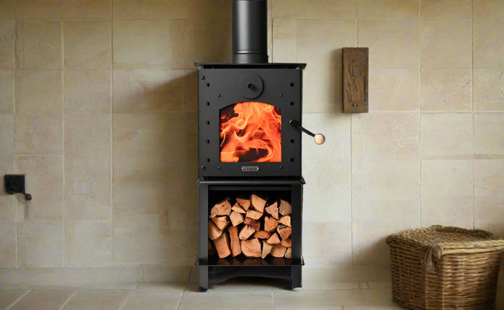 Warmington BLACK Studio 14 woodburner with flue system, featuring a cooktop and wood storage.