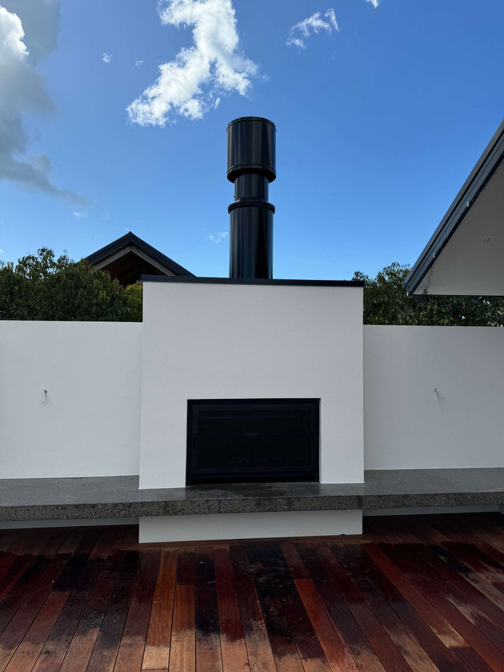 Outdoor fireplace with flue system on patio, featuring sleek design and robust construction, perfect for enhancing backyard aesthetics.