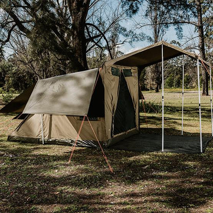 Oztent RV5 Plus tent with awning and poles set up in a grassy area.