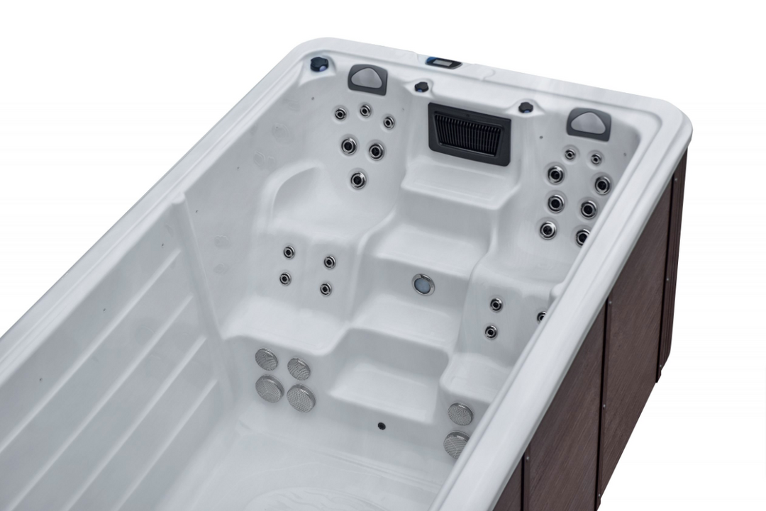 Sensation Delirium IV Pro 7.5m Swim Spa with white shell and hydrotherapy jets.