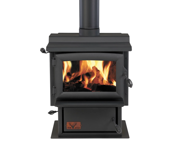 Woodsman Stag multi-fuel fire with visible flames and 4.2m heatsaver flue system.