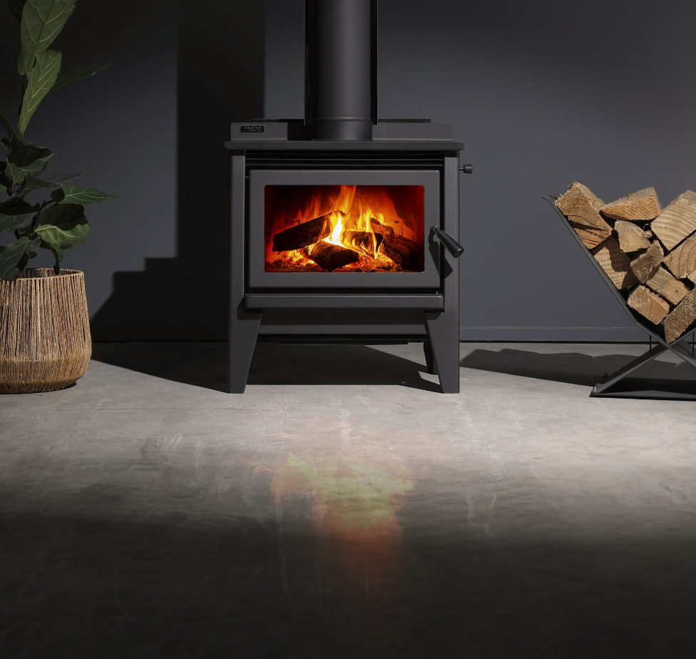 Metro Ultra Wee Rad freestanding wood stove with fire burning.