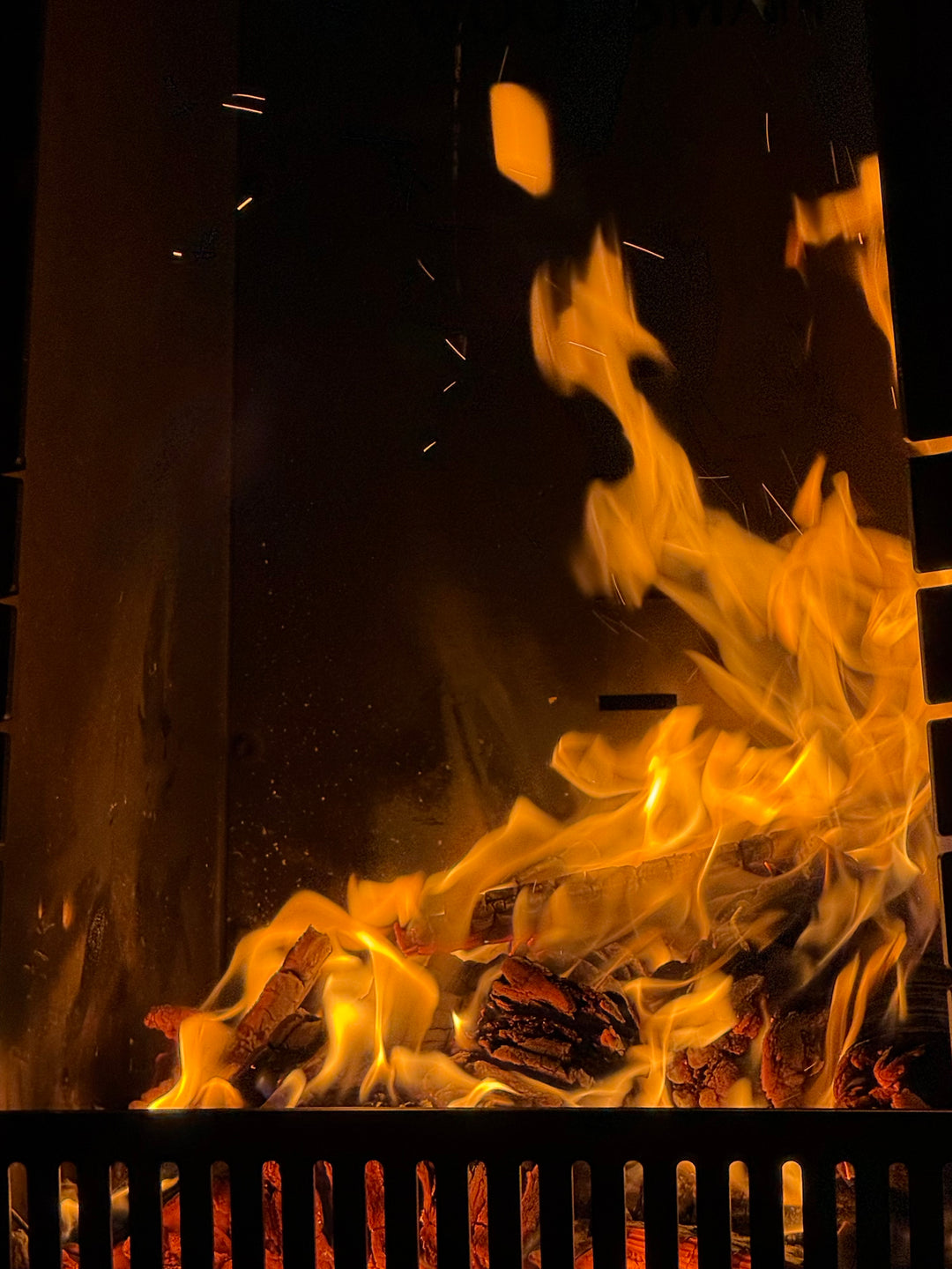 Close-up of flames and glowing embers in a fireplace