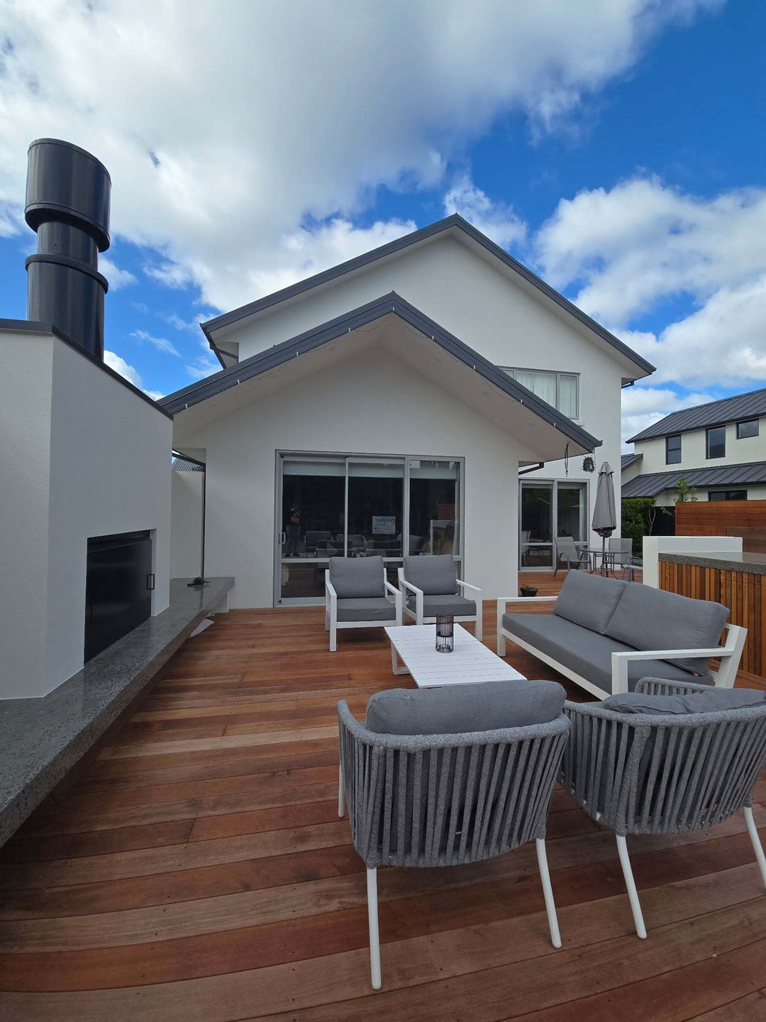 Sleek outdoor fireplace with 1.5m flue system on modern patio.