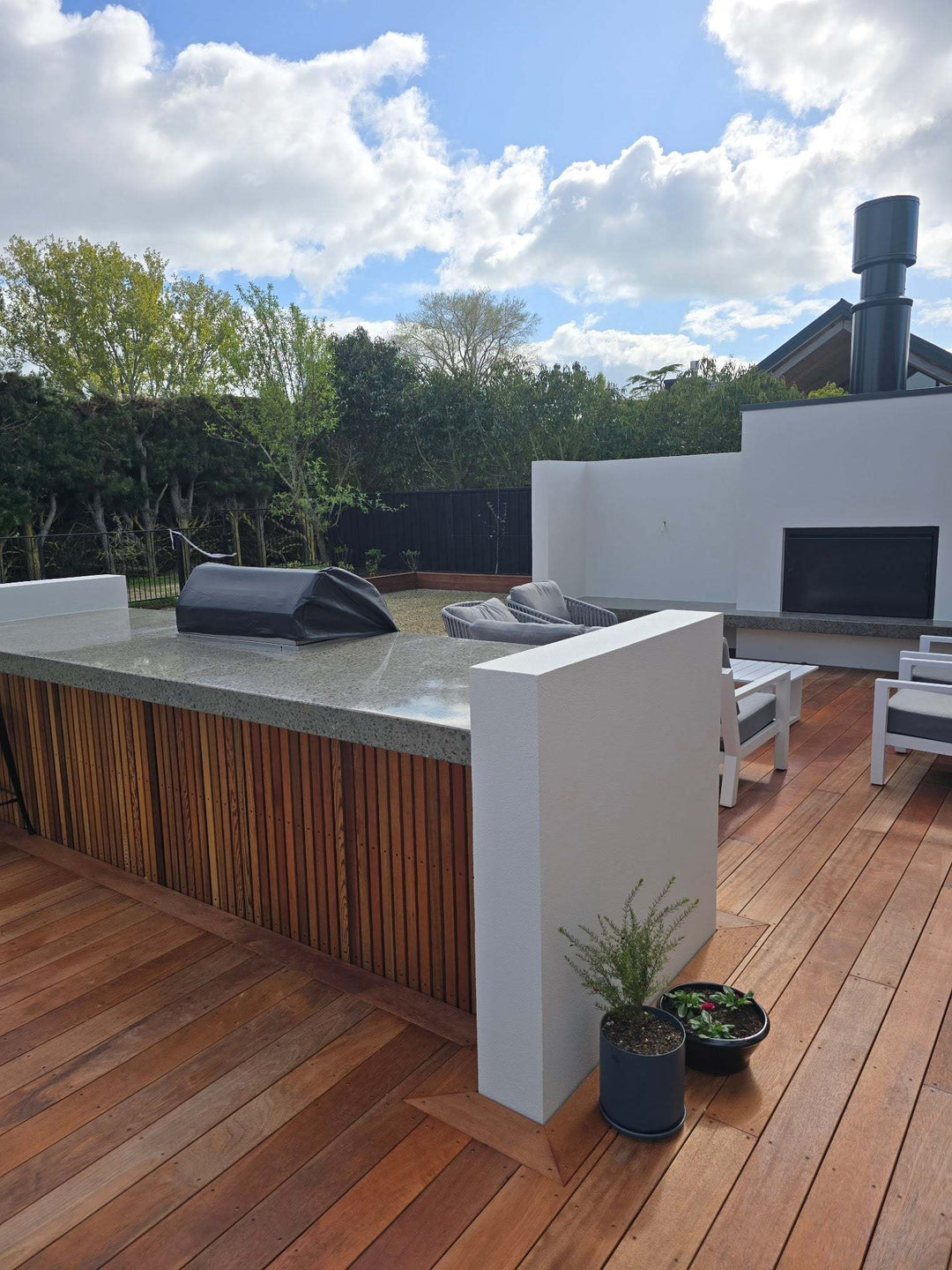 Outdoor patio featuring the sleek Onflame 1200 outdoor fireplace with 1.5m flue system, enhancing the backyard aesthetics.