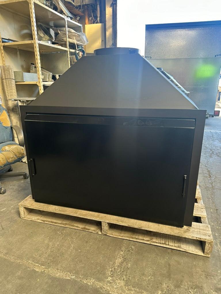 Onflame 1200 outdoor fireplace with matte black finish, featured in a workshop setting.