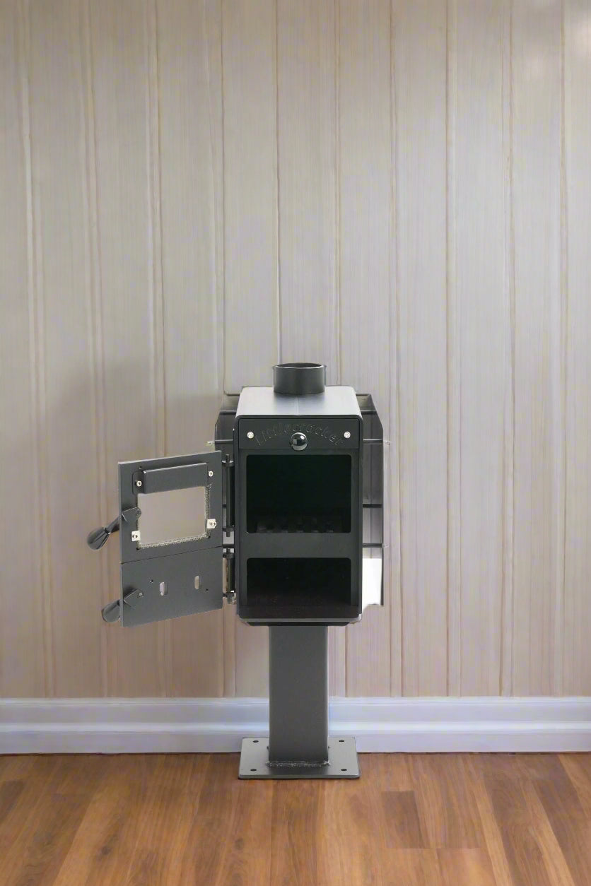 Compact Little Cracker multi-fuel fire unit with open door on pedestal, designed for versatile installations.