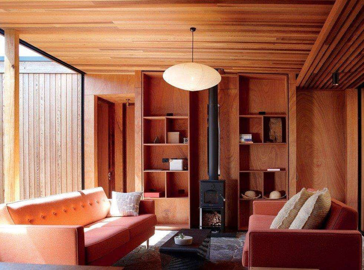 Warmington BLACK Studio 14 woodburner with flue system in modern living room.